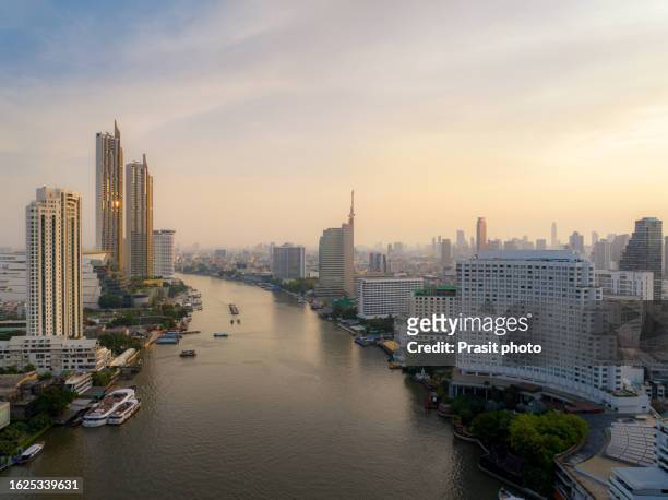 aerial view of the drone in bangkok shows the skyscrapers, streets and chao phraya river in the center of the city in bangkok, thailand. - river chao phraya stock pictures, royalty-free photos & images