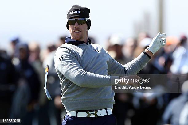 Hunter Mahan drops his club as after he hit a shot from the fairway on the eighth hole during the final round of the World Golf Championships -...