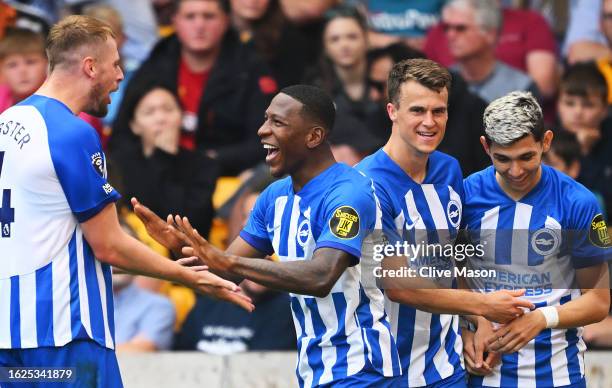 Pervis Estupinan of Brighton & Hove Albion celebrates with teammates after scoring the team's second goal during the Premier League match between...