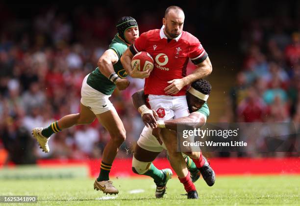 Cai Evans of Wales is tackled by Siya Kolisi and Cheslin Kolbe of South Africa during the Summer International match between Wales and South Africa...