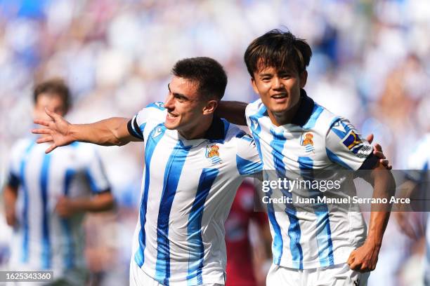 Ander Barrenetxea of Real Sociedad celebrates with teammate Takefusa Kubo after scoring the team's first goal during the LaLiga EA Sports match...