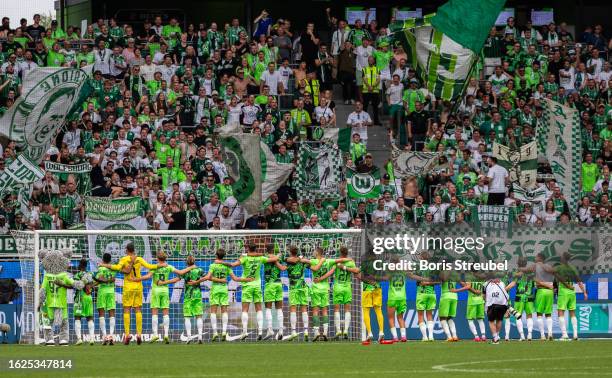 Players of VfL Wolfsburg celebrate with their fans after winning the Bundesliga match between VfL Wolfsburg and 1. FC Heidenheim 1846 at Volkswagen...