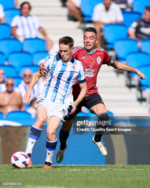 Benat Turrientes of Real Sociedad compete for the ball with Iago Aspas of RC Celta during the LaLiga EA Sports match between Real Sociedad and Celta...
