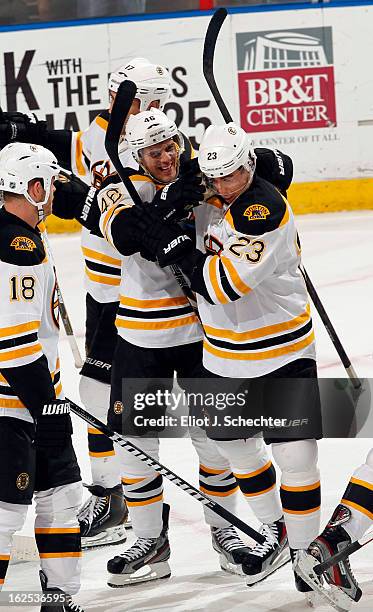 David Krejci of the Boston Bruins celebrates their 4-1 win with teammate Chris Kelly against the Florida Panthers at the BB&T Center on February 24,...