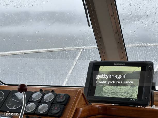 August 2023, Great Britain, Drumnadrochit: A photo of a Nessie movie prop is seen on the monitor of a boat on Loch Ness. What is believed to be the...