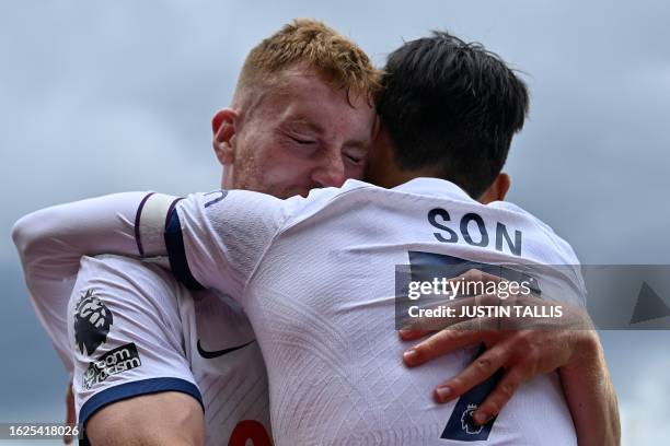 Tottenham Hotspur's Swedish midfielder Dejan Kulusevski celebrates with Tottenham Hotspur's South Korean striker Son Heung-Min after scoring his...