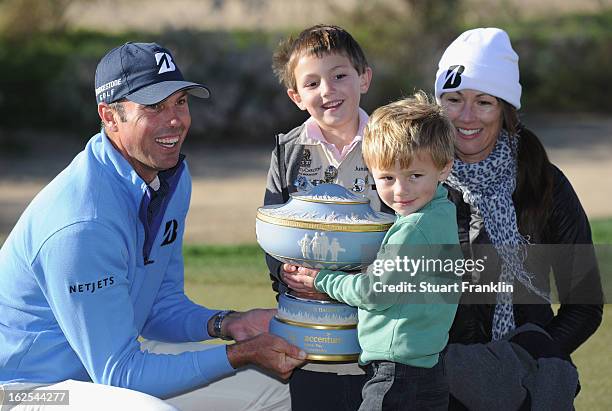 Matt Kuchar celebrates with the trophy as he poses with wife Sybi and sons Cameron and Carson after Kuchar won his championship match against Hunter...