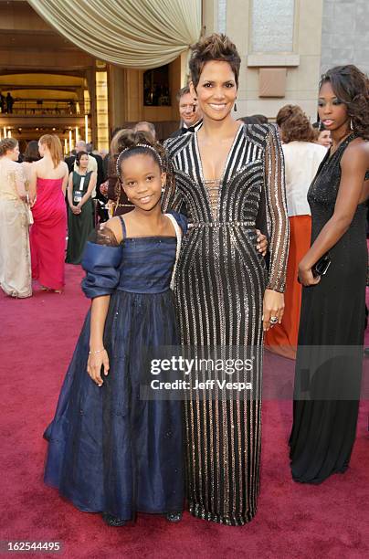 Actresses Quvenzhane Wallis and Halle Berry arrive at the Oscars at Hollywood & Highland Center on February 24, 2013 in Hollywood, California.