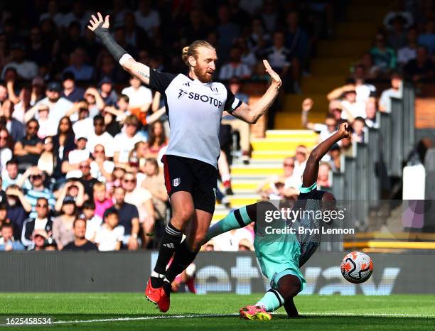 Tim Ream of Fulham clashes Yoane Wissa of Brentford to give away a penalty during the Premier League match between Fulham FC and Brentford FC at...