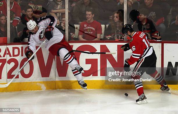 James Wisniewski of the Columbus Blue Jackets slips and kicks the stick away from Marcus Kruger of the Chicago Blackhawks at the United Center on...