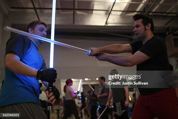 Students perform combat moves using lightsabers during a Golden Gate Knights class in saber choreography on February 24, 2013 in San Francisco,...