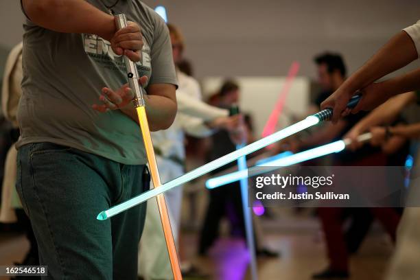 Students perform combat moves using lightsabers during a Golden Gate Knights class in saber choreography on February 24, 2013 in San Francisco,...