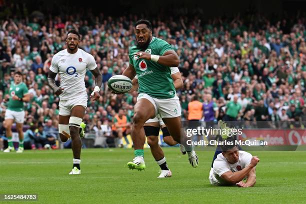 Bundee Aki of Ireland runs through for his team's first try during the Summer International match between Ireland and England at Aviva Stadium on...