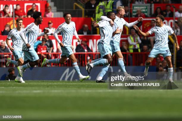 Nottingham Forest's Ivorian Coast defender Willy Boly celebrates with teammates after scoring his team's second goal during the English Premier...