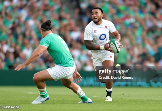 Manu Tuilagi of England takes on James Lowe during the Summer International match between Ireland and England at the Aviva Stadium on August 19, 2023...