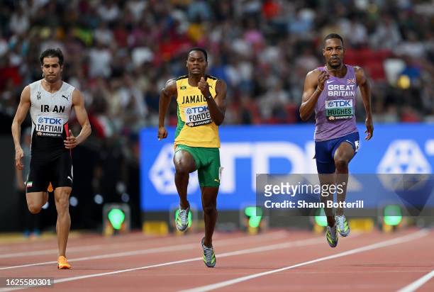 Hassan Taftian of Team Iran, Ryiem Forde of Team Jamaica and Zarnel Hughes of Team Great Britain compete in heat 1 of the Men's 100m during day one...