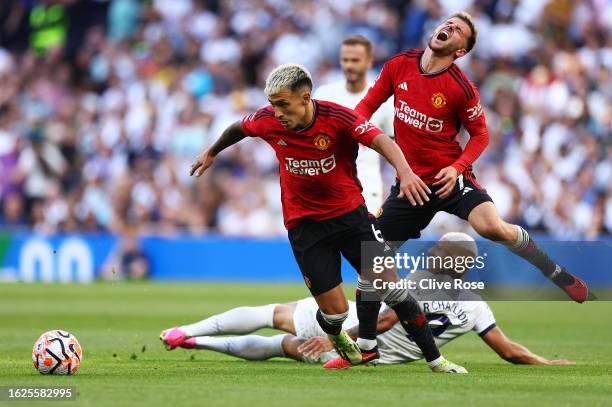 Richarlison of Tottenham Hotspur clashes with Lisandro Martinez and Mason Mount of Manchester United during the Premier League match between...