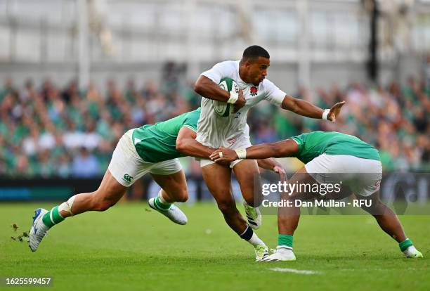 Anthony Watson of England is tackled by James Lowe and Bundee Aki of Ireland during the Summer International match between Ireland and England at...