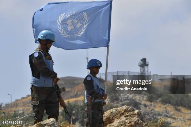 The United Nations Interim Peace Forces stand guard holding the flag of the United Nations by the border at the Kafr Shuba region, considered a...