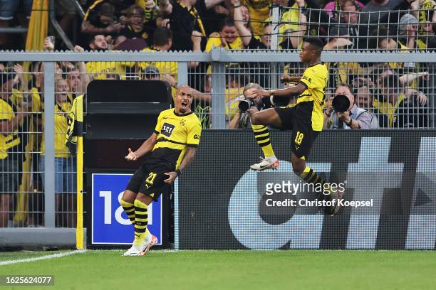 Donyell Malen of Borussia Dortmund celebrates with teammate Youssoufa Moukoko after scoring the team's first goal during the Bundesliga match between...