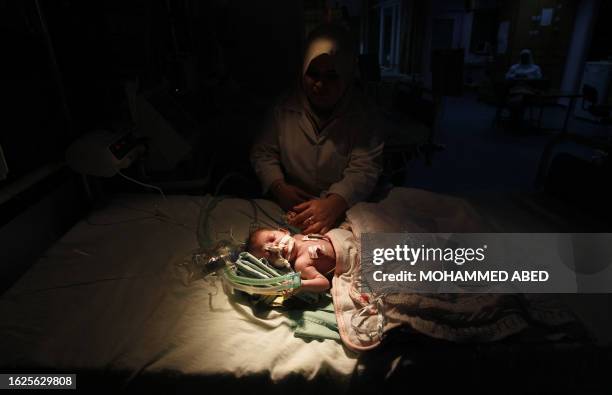 Palestinian baby receives treatment at the intensive care unit at a hospital where they are using generators to maintain medical support units in...