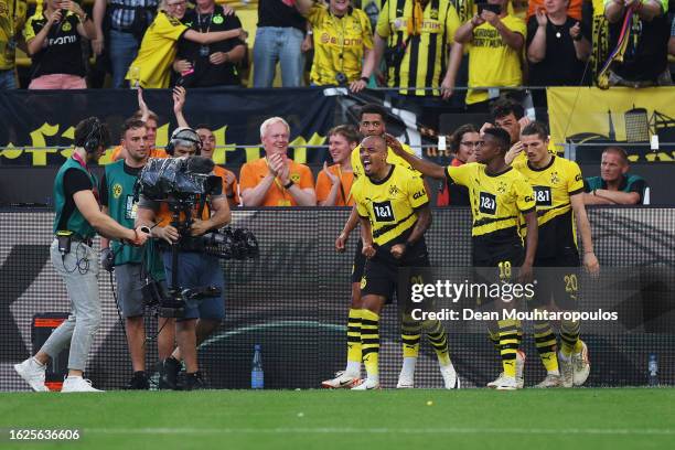 Donyell Malen of Borussia Dortmund celebrates with teammate Youssoufa Moukoko after scoring the team's first goal during the Bundesliga match between...