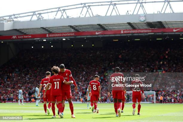 Mohamed Salah of Liverpool celebrates with teammate Virgil van Dijk after scoring the team's second goal during the Premier League match between...