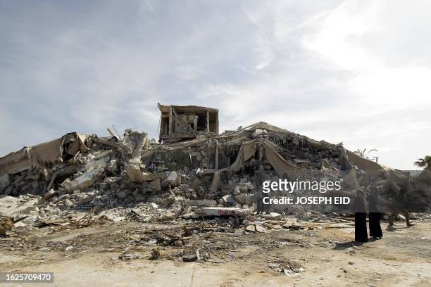 Libyans arrive to inspect on November 1 the rubble of the destroyed "Beit al-Samed" or "The Resisting House", as dubbed by slain Libyan leader Moamer...