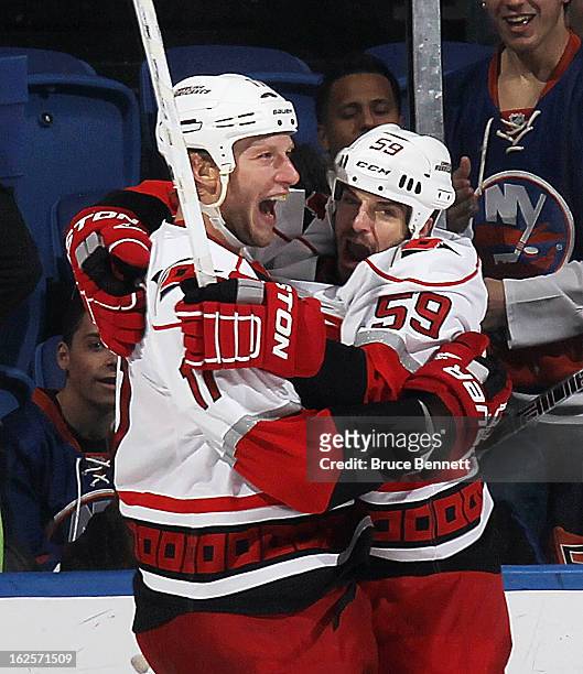 Jordan Staal of the Carolina Hurricanes scores the tying goal at 19:13 of the second period against the New York Islanders and is joined by Chad...