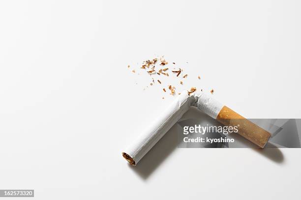 isolated shot of broken cigarette on white background - cigarette stock pictures, royalty-free photos & images
