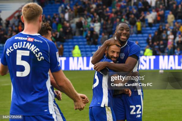 Mark McGuinness, Yakou Méïte and Manolis Siopis of Cardiff City FC hug during the Sky Bet Championship match between Cardiff City and Sheffield...