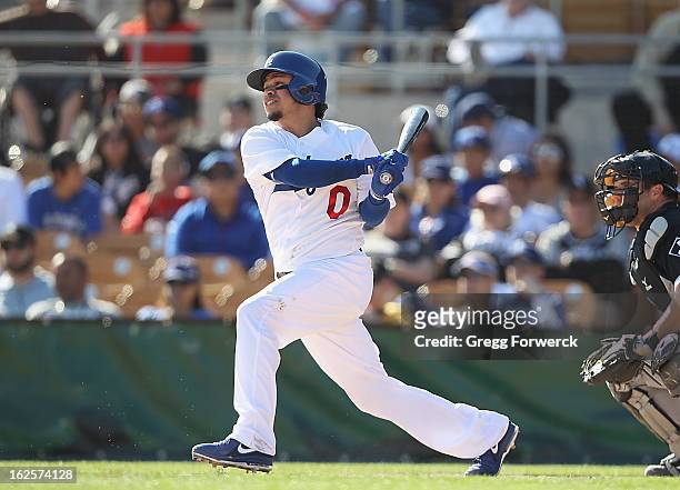 Alfredo Amezaga#0 of the Los Angeles Dodgers hits the ball of the during their spring training baseball game against the Chicago White Sox at...
