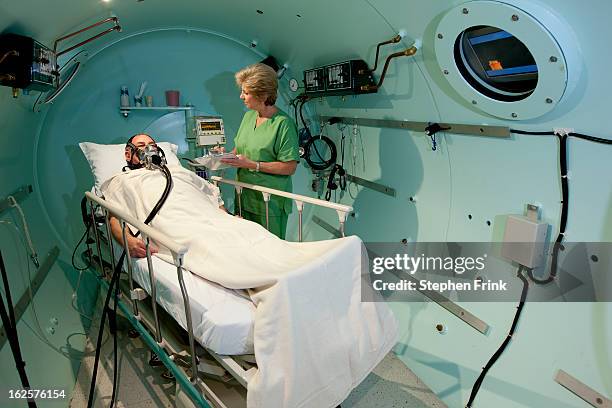 medical treatment inside hyperbaric chamber - monroe county florida stock pictures, royalty-free photos & images