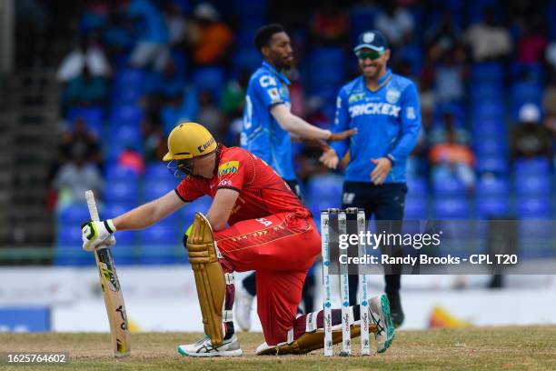 Martin Guptill of Trinbago Knight Riders express disappointment as Khary Pierre and Faf Du Plessis of Saint Lucia Kings celebrate his dismissal...