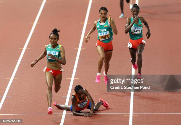 Sifan Hassan of Team Netherlands falls as Gudaf Tsegay of Team Ethiopia leads the Women's 10,000m Final during day one of the World Athletics...