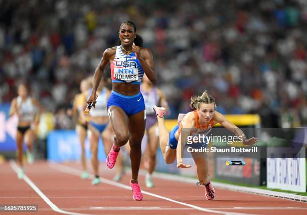 Alexis Holmes of Team United States crosses the finish line to win the 4x400m Mixed Relay Final as Femke Bol of Team Netherlands falls during day one...