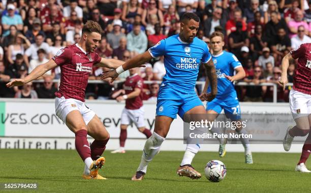 Jonson Clarke-Harris of Peterborough United controls the ball under pressure from Sam Sherring of Northampton Town during the Sky Bet League One...