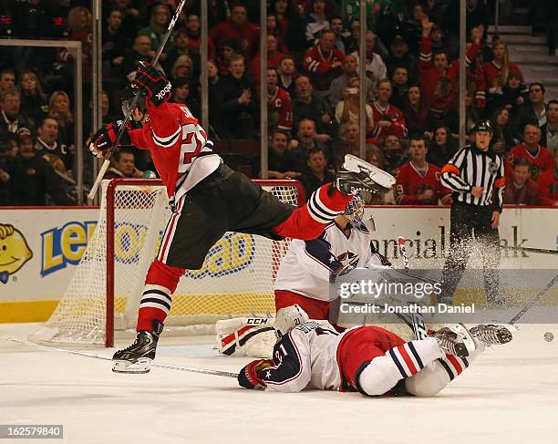 Brandon Saad of the Chicago Blackhawks leaps over James Wisniewski of the Columbus Blue Jackets at the United Center on February 24, 2013 in Chicago,...