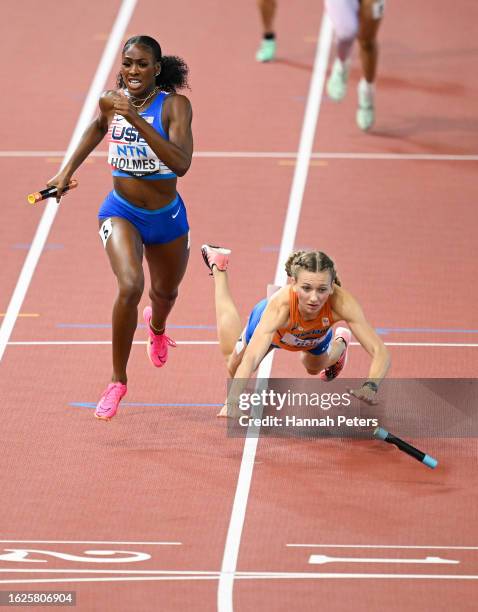 Alexis Holmes of Team United States crosses the finish line to win the 4x400m Mixed Relay Final as Femke Bol of Team Netherlands falls during day one...