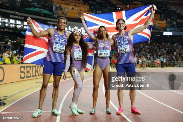 Rio Mitcham, Yemi Mary John, Laviai Nielsen and Lewis Davey of Team Great Britain pose for a photo with the British flag after winning the Silver...