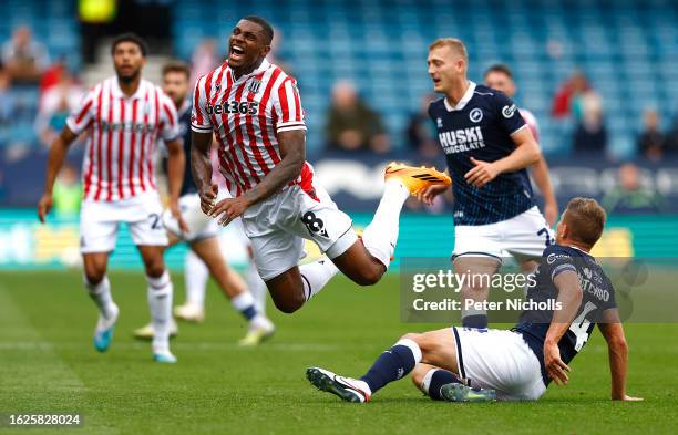 Stoke City's Wesley is fouled by Shaun Hutchinson during the Sky Bet Championship match between Millwall and Stoke City at The Den on August 26, 2023...