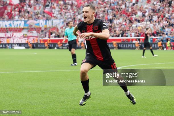 Florian Wirtz of Bayer 04 Leverkusen celebrates after scoring his team's third goal with teammates during the Bundesliga match between Bayer 04...