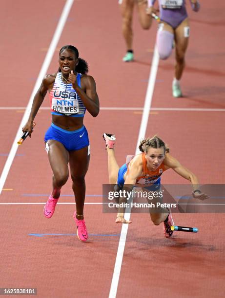 Alexis Holmes of Team United States crosses the finish line to win the 4x400m Mixed Relay Final as Femke Bol of Team Netherlands falls during day one...