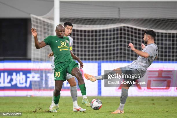 Nyasha Mushekwi of Zhejiang FC and Frans Putros and Tanaboon Kesarat of Port FC seen in action during the AFC Champion League Qualify Play off match...