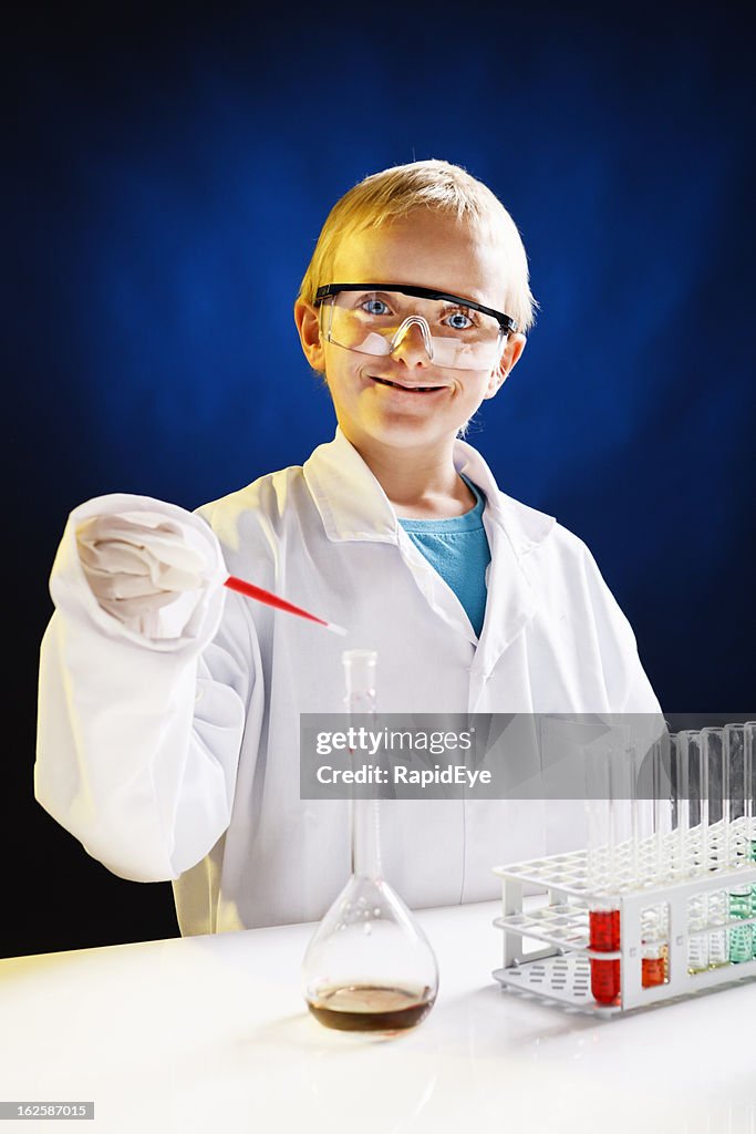 Junior genius: 8 year old scientist enjoying his lab work!