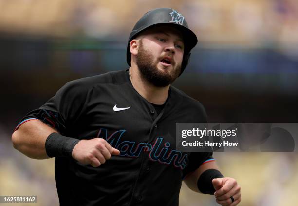 Jake Burger of the Miami Marlins reacts after scoring on a Bryan De La Cruz double, to take a 1-0 lead over the Los Angeles Dodgers during the fourth...