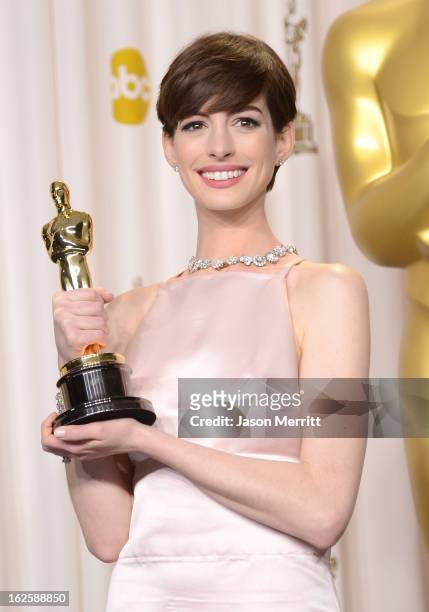 Actress Anne Hathaway, winner of the Best Supporting Actress award for "Les Miserables," poses in the press room during the Oscars held at Loews...