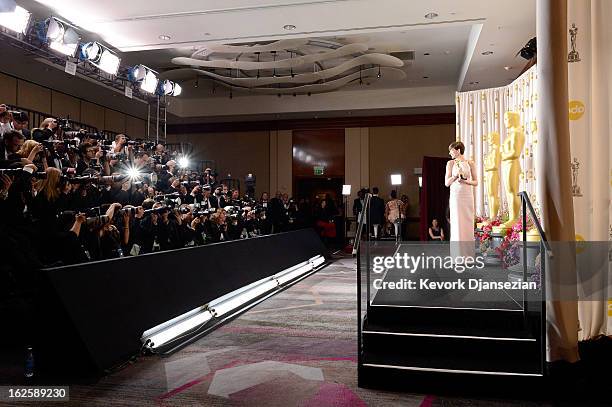 Actress Anne Hathaway poses with the Best Supporting Actress award for 'Les Miserables' in the press room during the Oscars held at Loews Hollywood...