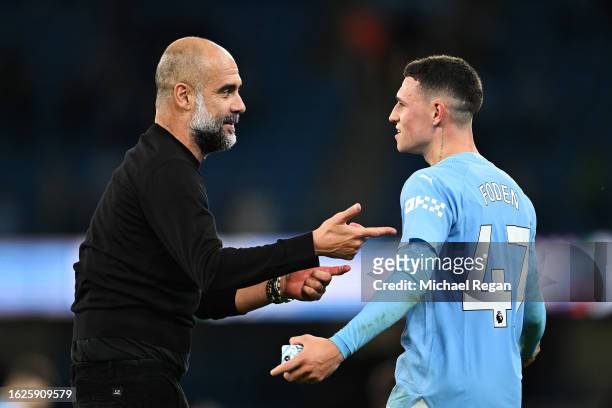 Pep Guardiola, Manager of Manchester City, celebrates with Phil Foden following the team's victory during the Premier League match between Manchester...