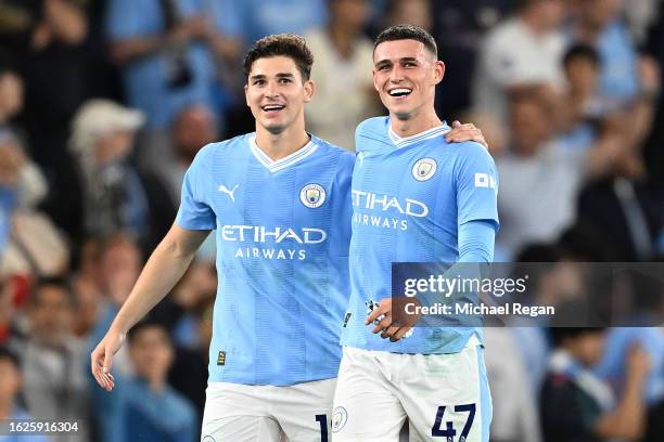 Julian Alvarez and Phil Foden of Manchester City celebrate following the team's victory during the Premier League match between Manchester City and...